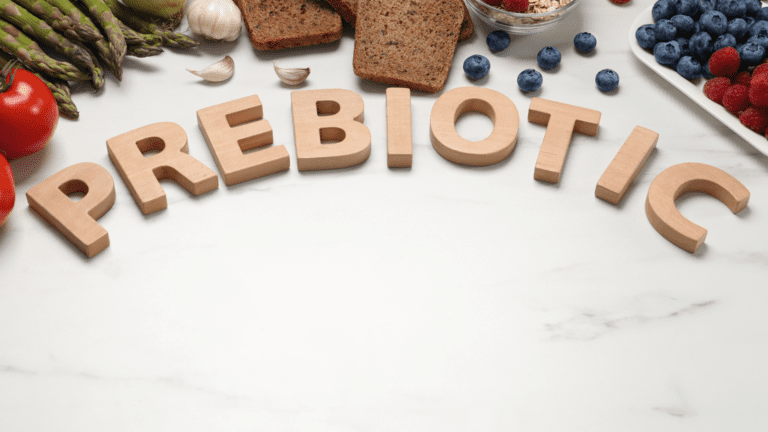 This image depicts a variety of prebiotic-rich foods, including bananas, onions, garlic, apples, and chicory root. These foods are known for their high fiber content, which promotes gut health by feeding beneficial bacteria. The vibrant colors and textures of these foods underscore their natural, unprocessed state, suggesting their nutritional benefits. Each food item is clearly identifiable, illustrating the wide range of prebiotic sources available in a balanced diet.