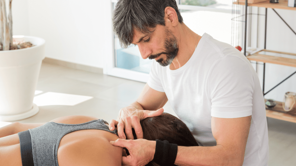 An image showing a man expertly massaging a woman's trapezius muscle, targeting a trigger point for pain relief and muscle relaxation.