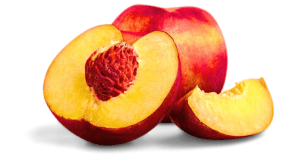 A whole ripe peach and a halved peach, revealing its pit and luscious flesh, are showcased in an up-close image set against a clean white background.